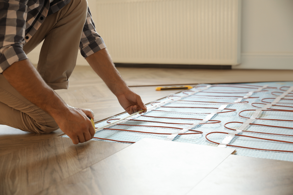 Professional,Worker,Installing,Electric,Underfloor,Heating,System,Indoors,,Closeup